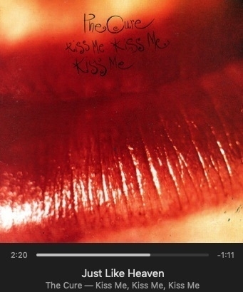 Screenshot of music player showing album cover for The Cure's song 'Just Like Heaven' from the album 'Kiss Me, Kiss Me, Kiss Me' depicting extreme closeup on feminine lips with red lipstick